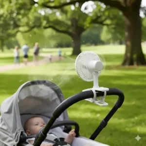 A portable battery-operated clip-on fan with a safety grill attached to a baby pram handle for summer walks.
