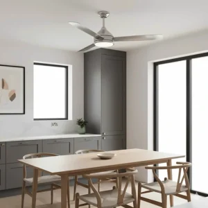 A brushed chrome DC motor ceiling fan positioned above a wooden dining table in a modern Shaker-style UK kitchen with grey cabinetry.