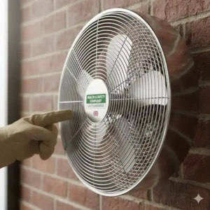 Close-mesh safety finger guard on a chrome-finished industrial fan for workshop health and safety compliance.
