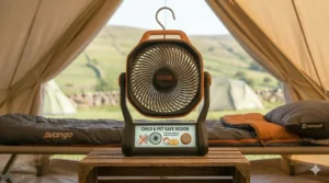 A photorealistic 4K image showing the Explore battery powered camping fan on a wooden crate, with an integrated digital display illustrating its child and pet safe design featuring a fine-mesh protective grille.