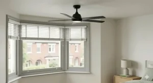 A ceiling fan with integrated lighting installed in a neutral, modern British bedroom.
