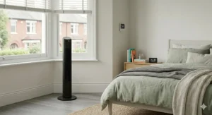 A comfortable, cool bedroom setup during a heatwave, featuring a top-rated pedestal fan.