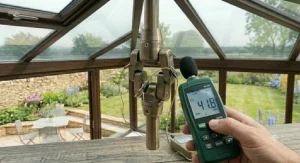 An interior view of a cosy conservatory in winter with a reversible ceiling fan circulating warm air downwards from the roof ridge to save on energy bills.