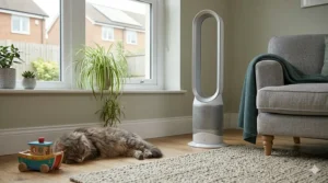 A slimline, quiet tower fan tucked neatly into the corner of a typical British terraced house living room.