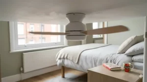A low-profile timber ceiling fan with integrated LED light fitted to a low-height bedroom ceiling.