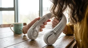 A stylish, modern best neck fan being worn as a practical accessory during an outdoor walk