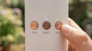 Control buttons on a multi-speed handheld misting fan showing airflow settings.