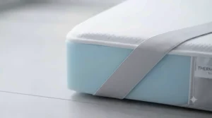 Detailed view of the elasticated anchor straps securing the cooling mattress pad firmly to the bed.