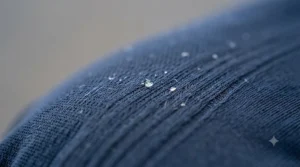 Macro detail of the cooling work shirt fabric showing moisture-wicking technology.