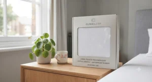 A rolled cooling mattress protector in eco-friendly packaging ready for unboxing in a British home.
