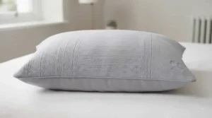 Standard-sized cooling pillowcase fitted neatly over a plush bed pillow, showcasing a crisp and tailored British finish.