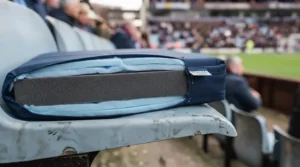 Cross-section view of a thick memory foam stadium seat cushion for long sporting events.