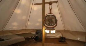 Battery-operated camping fan with integrated LED lantern hanging inside a bell tent during a UK getaway.
