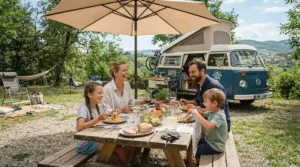 Family enjoying a shaded meal outside, supported by rated motorhome cooling solutions during a coastal holiday.