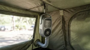 Comparing a tent fan vs clip-on fan suspended from the ceiling hook of a backpacking shelter.